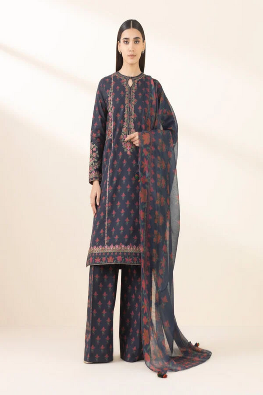 Woman wearing a traditional outfit with a dark blue and red pattern on a white background