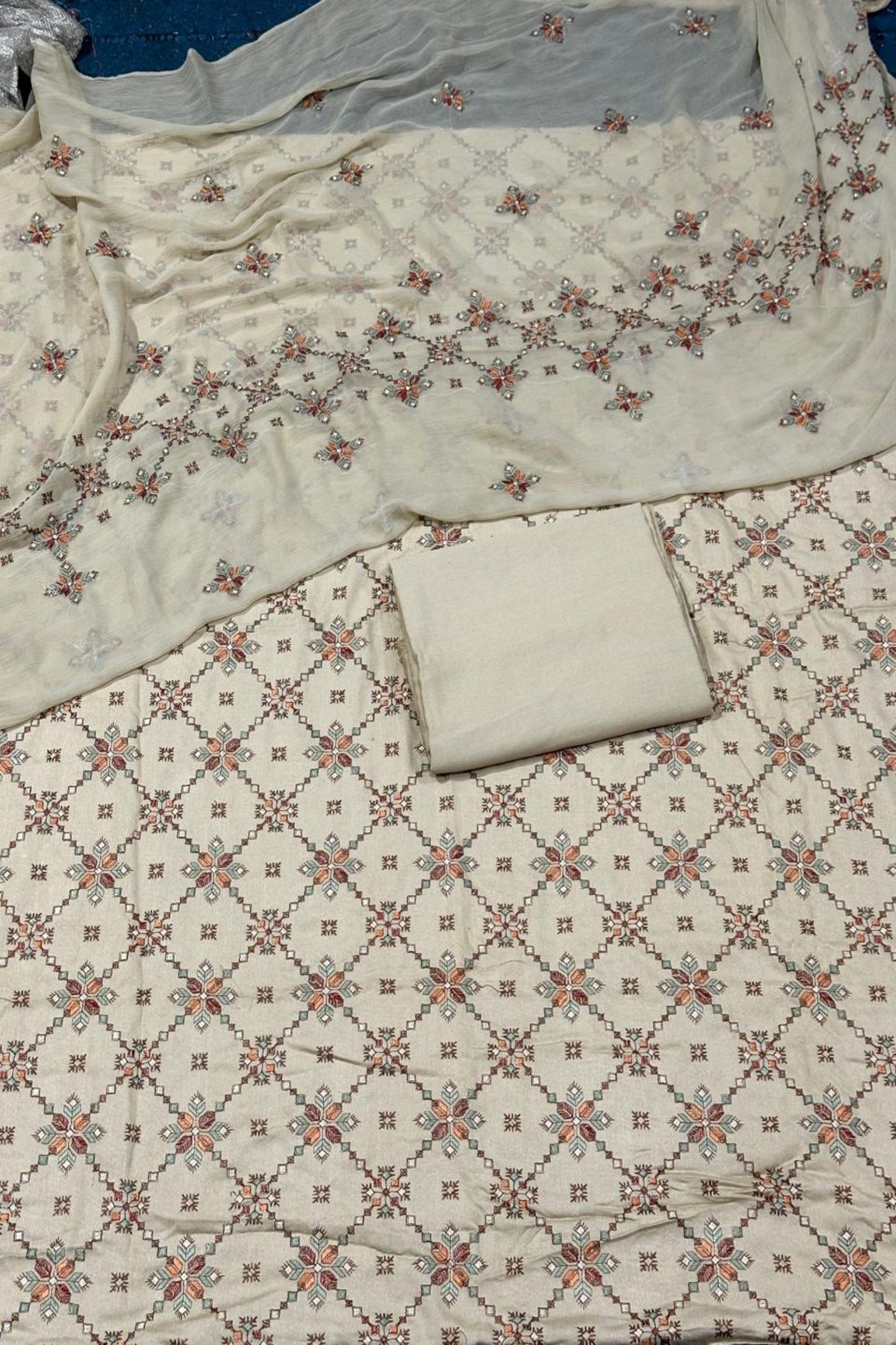 Floral patterned fabric with a white pillow on a matching fabric background
