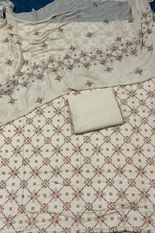 Floral patterned fabric with a white pillow on a matching fabric background