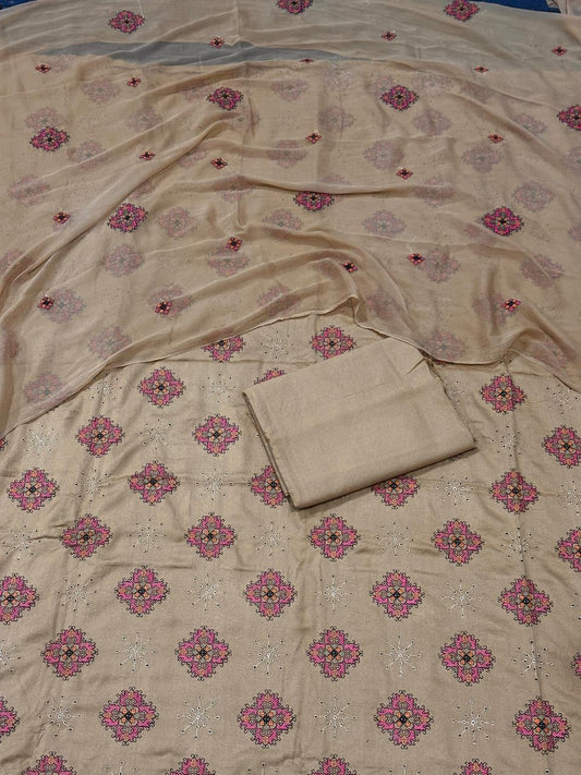Beige fabric with pink floral patterns on a blue background