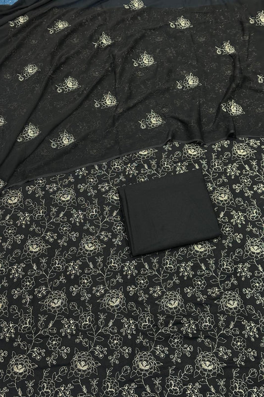 Black fabric with floral pattern and a black wallet on top