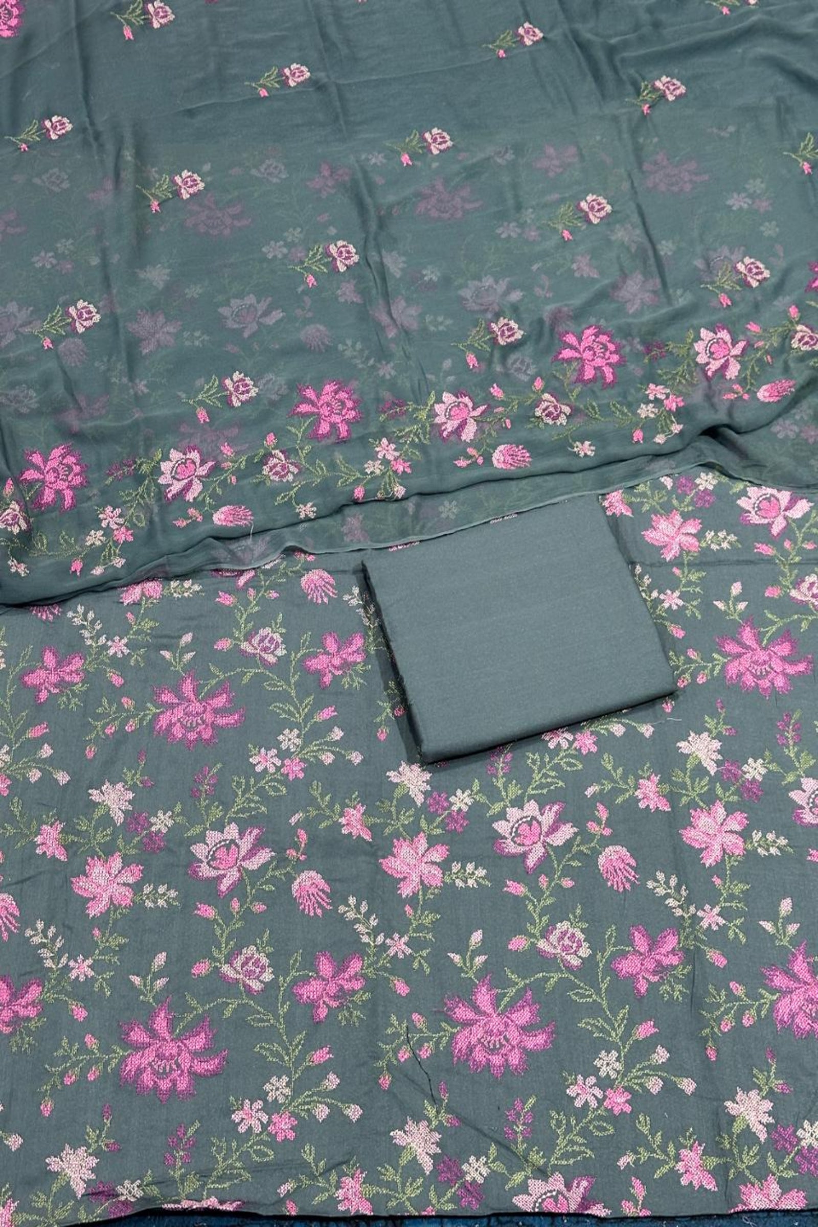 Floral patterned fabric with pink flowers on a teal background