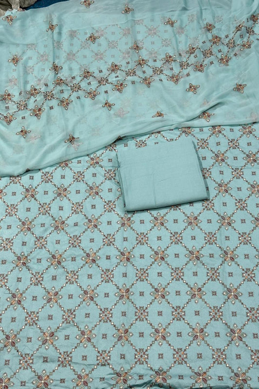 Teal fabric with floral patterns on a matching background
