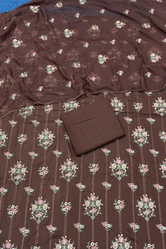 Brown fabric with floral pattern and a folded brown square on top