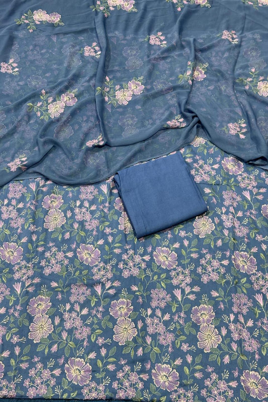Blue fabric with floral pattern and a folded blue fabric piece on top