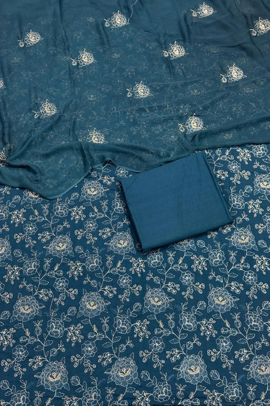 Blue fabric with white floral patterns on a matching blue background