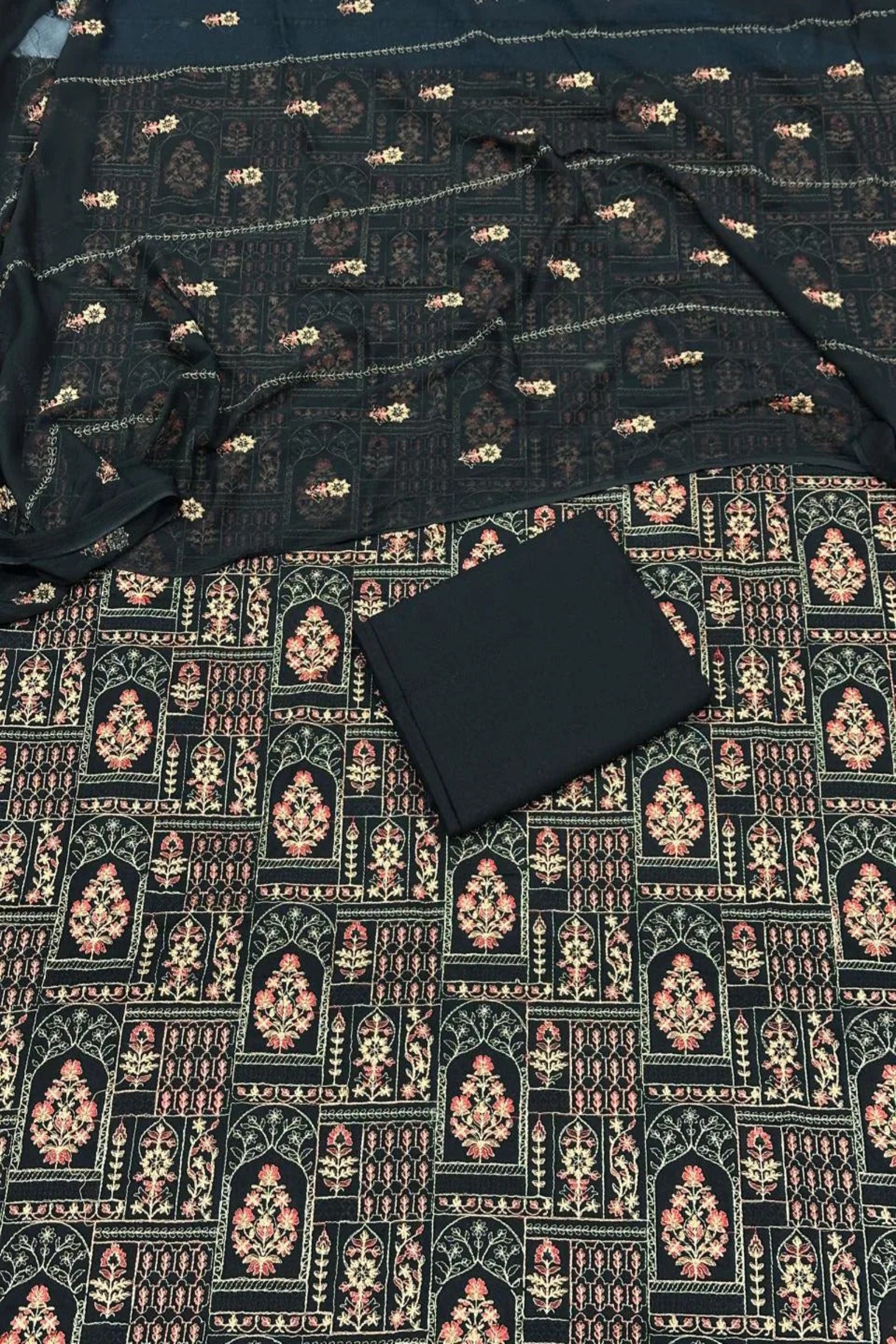 Black fabric with intricate patterns on a dark background