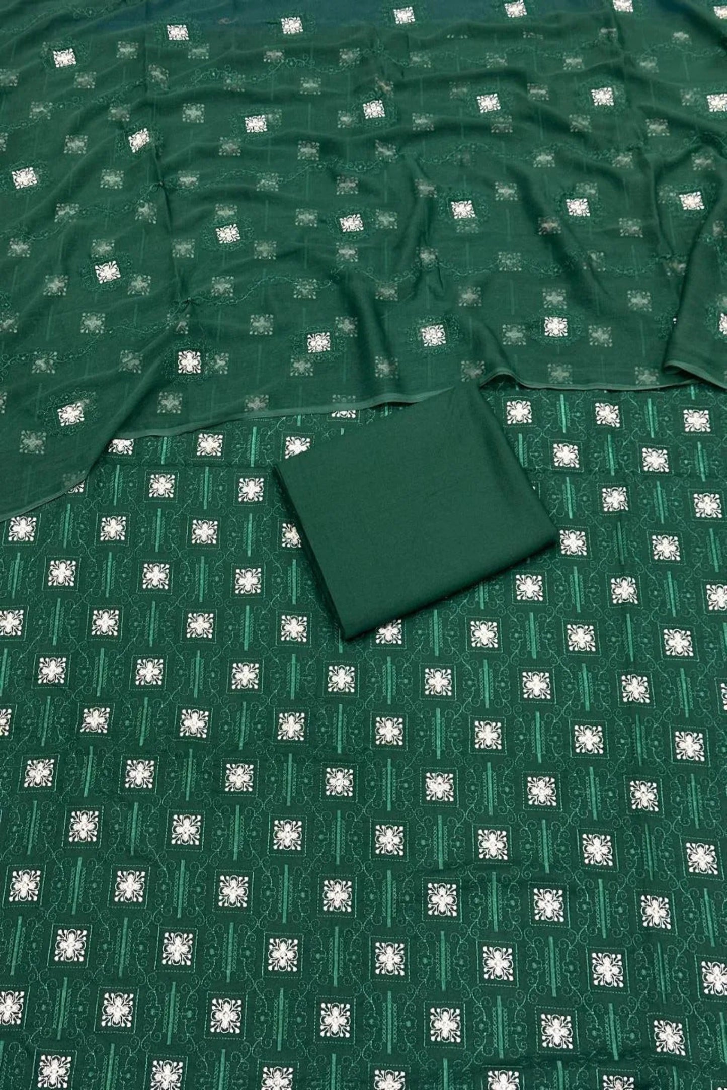 Green fabric with a subtle pattern on a flat surface
