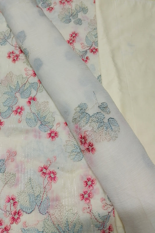 Floral-patterned fabric with pink and blue flowers on a white background