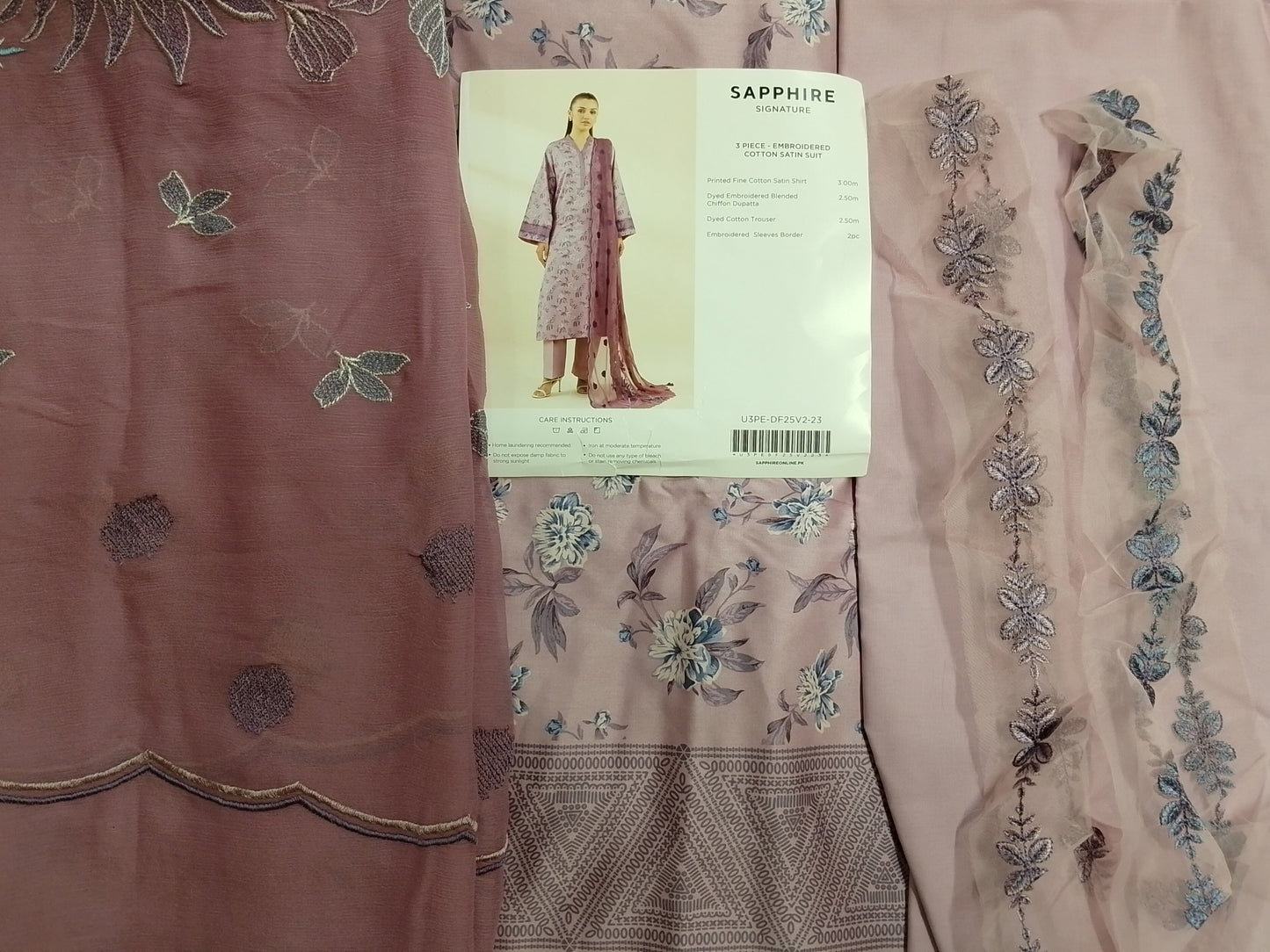 Embroidered fabric with a pattern and a 'Sapphire' label on a light background