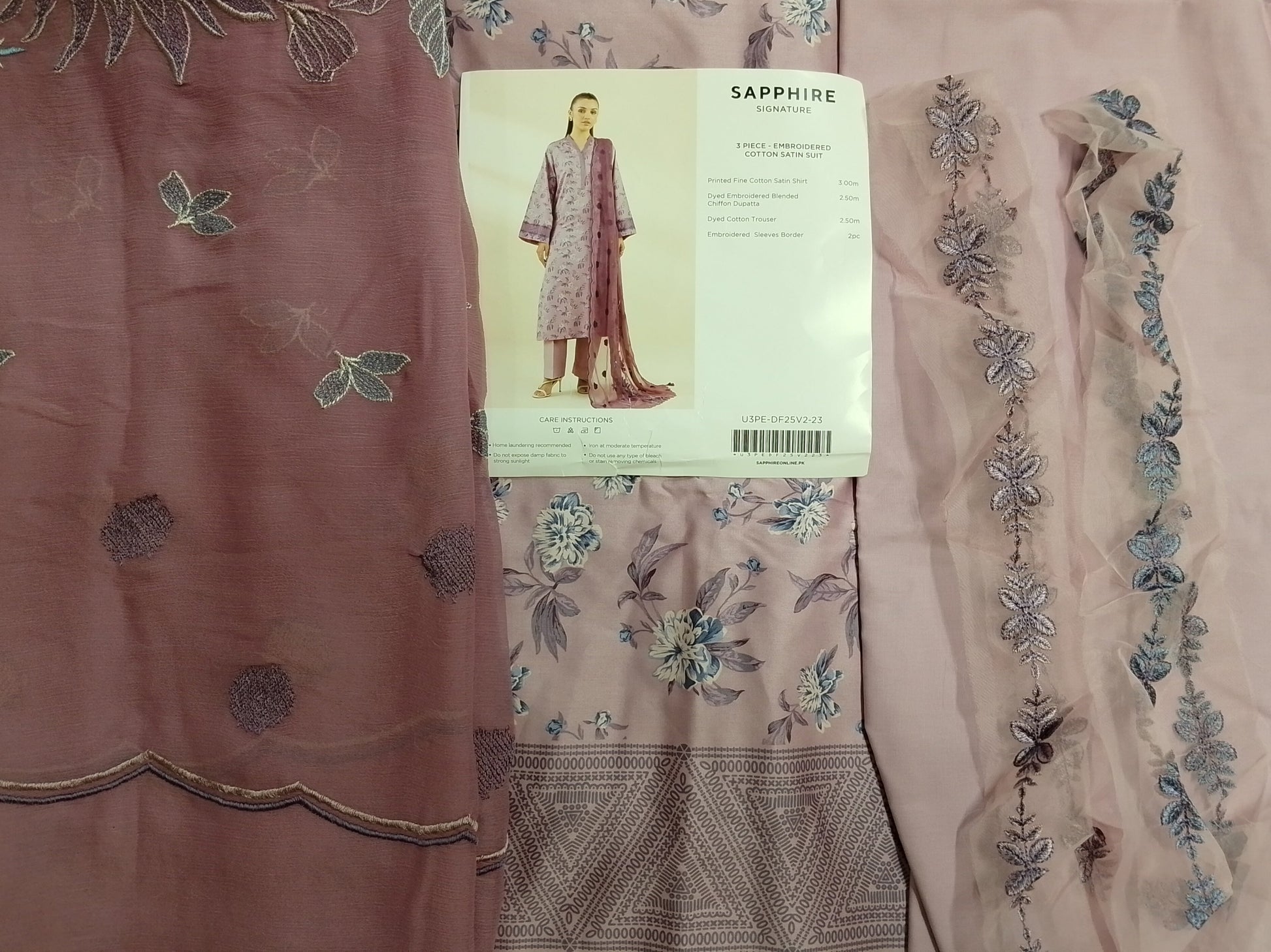 Embroidered fabric with a pattern and a 'Sapphire' label on a light background