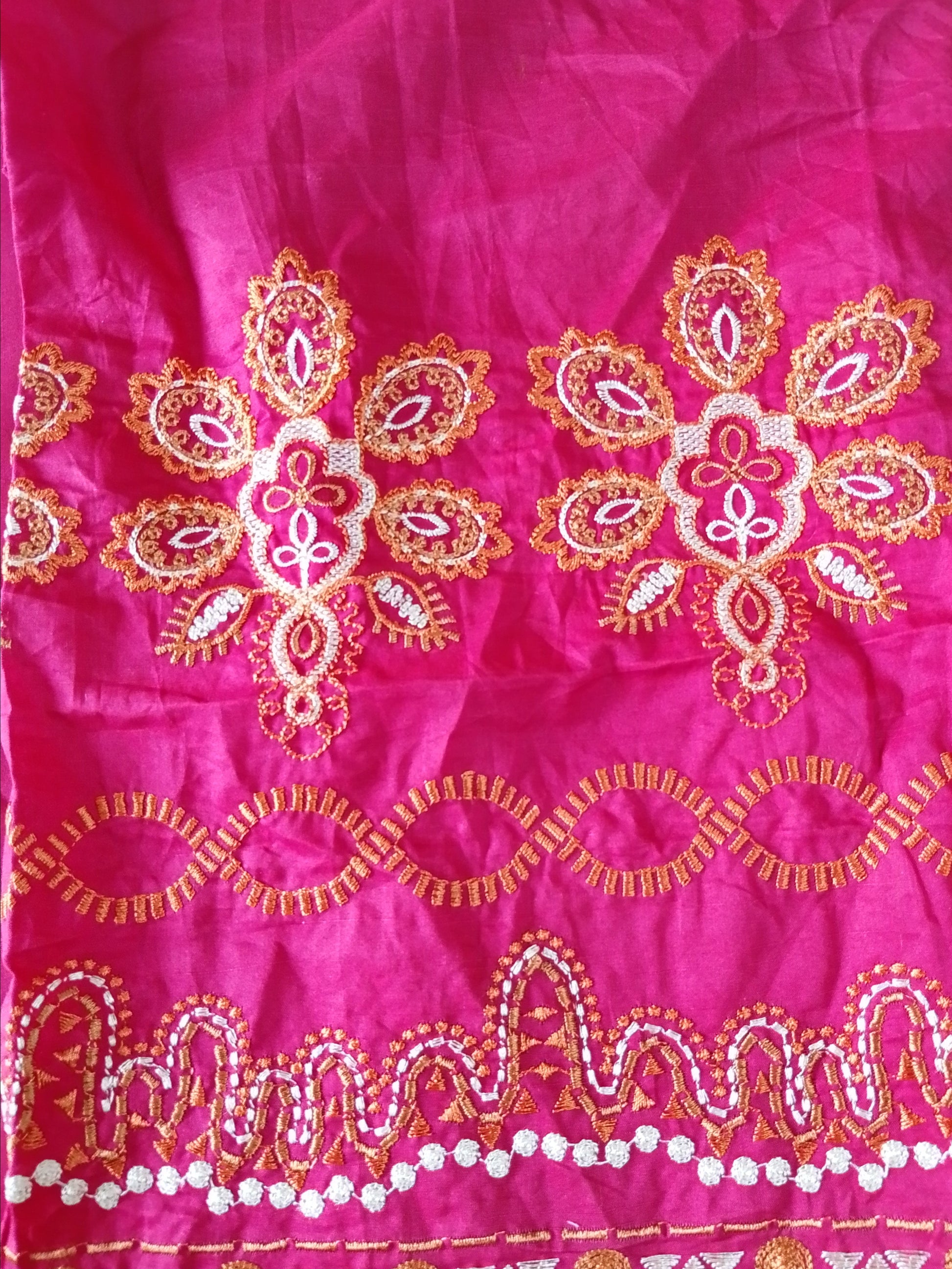 Pink fabric with gold embroidery and patterns