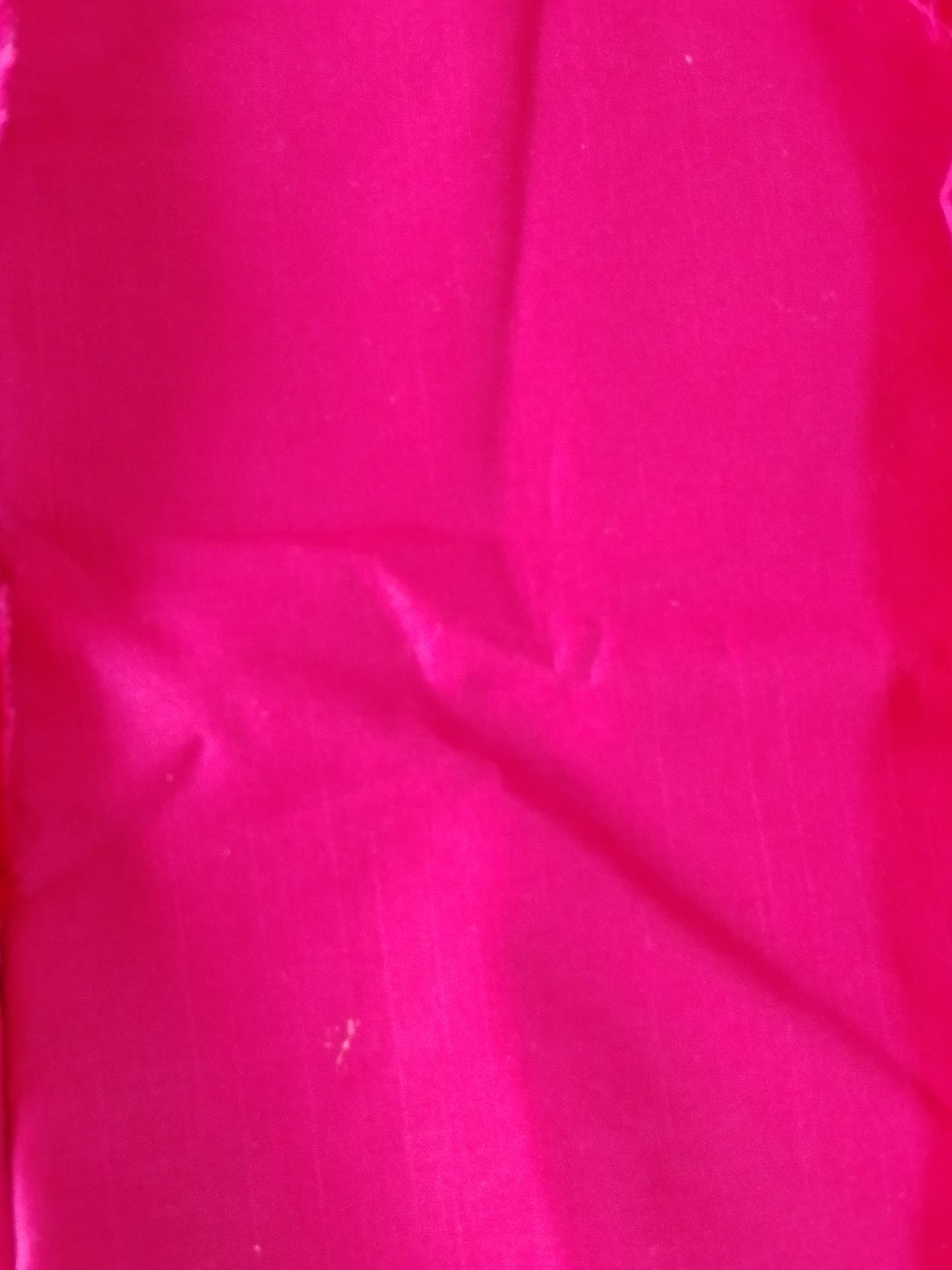 Pink fabric with a textured surface and subtle pattern