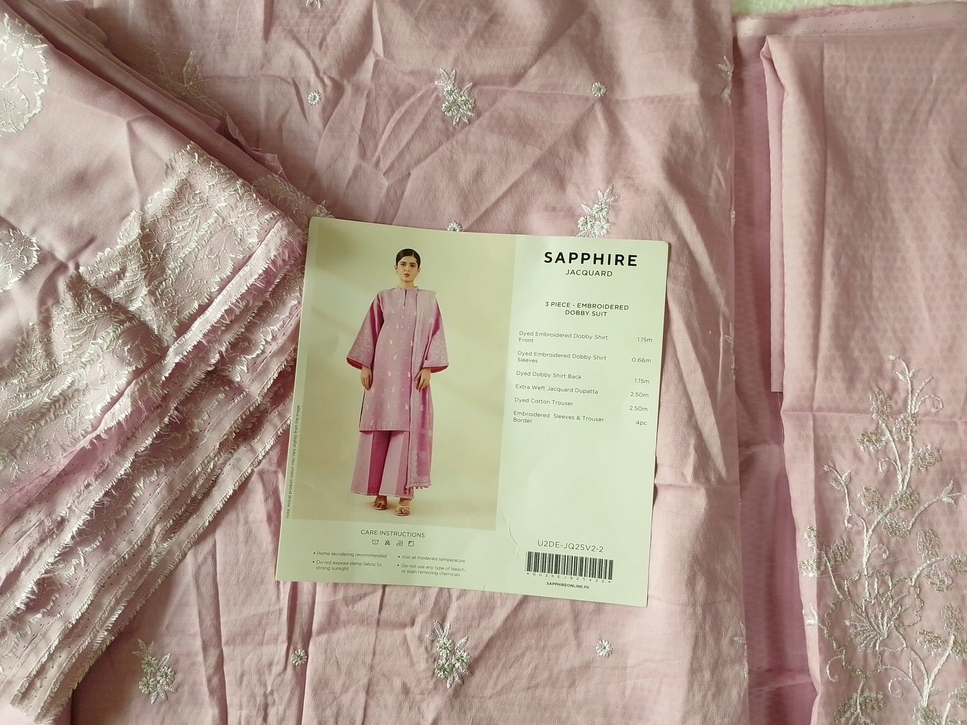 Pink fabric with a pattern and a card on top