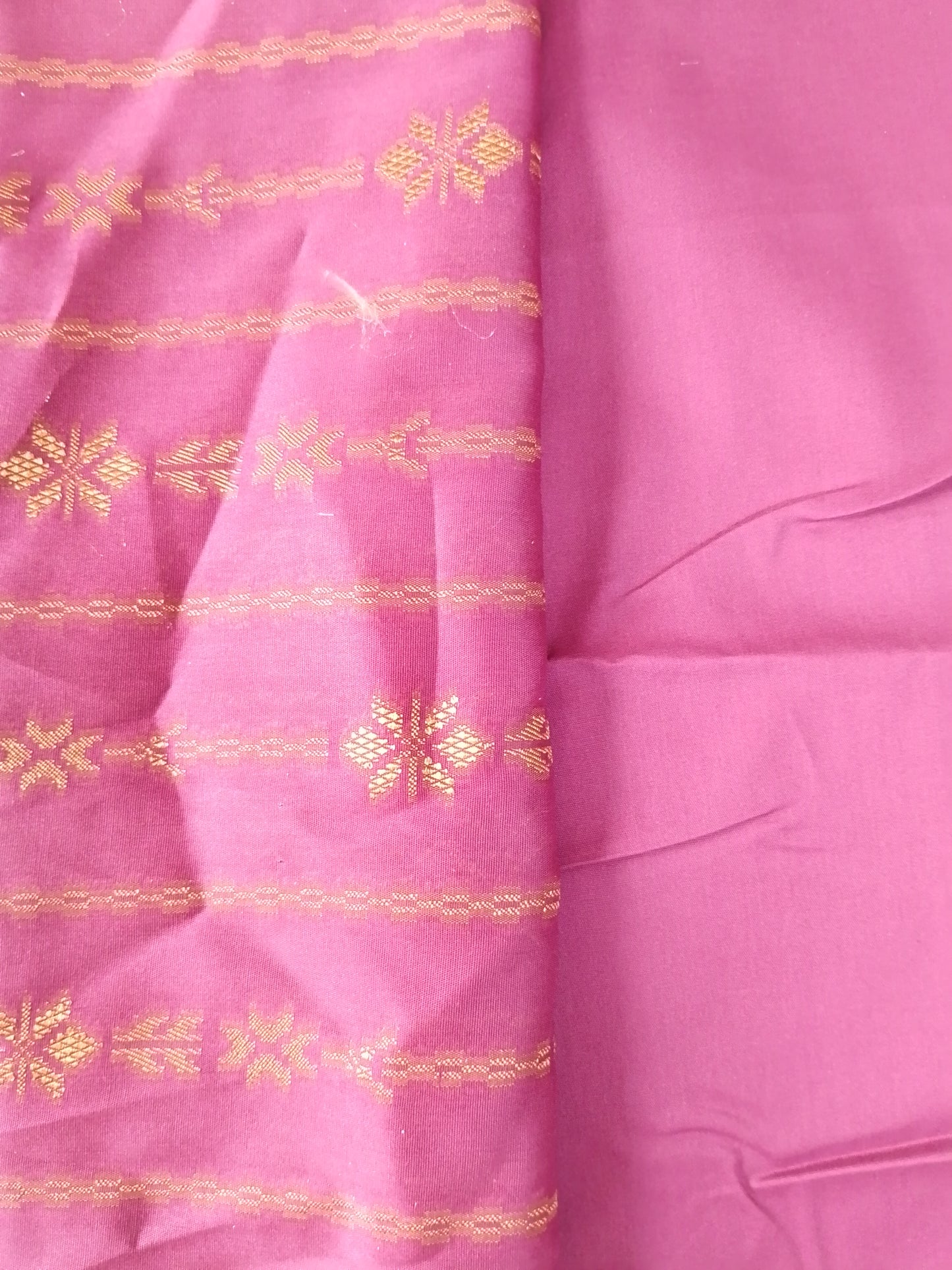 Pink fabric with gold embroidery patterns