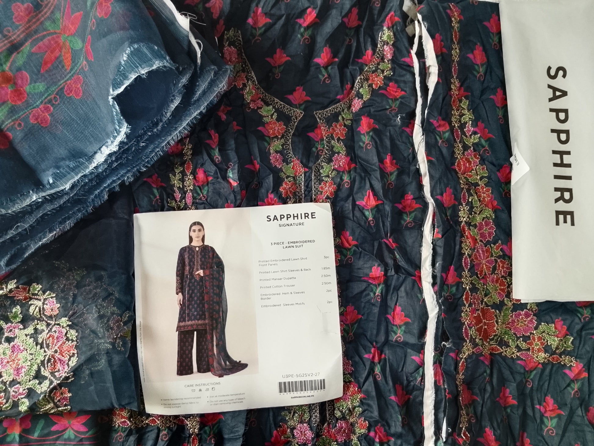 Floral fabric with a pattern and a magazine on top, featuring the brand 'Sapphire'.