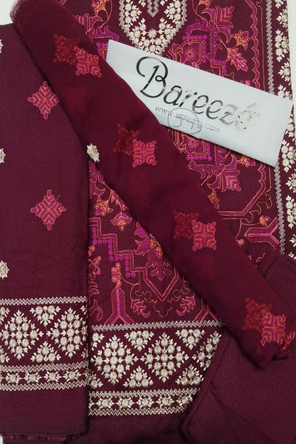 Maroon fabric with intricate patterns and 'Bareeze' branding on a matching fabric background.