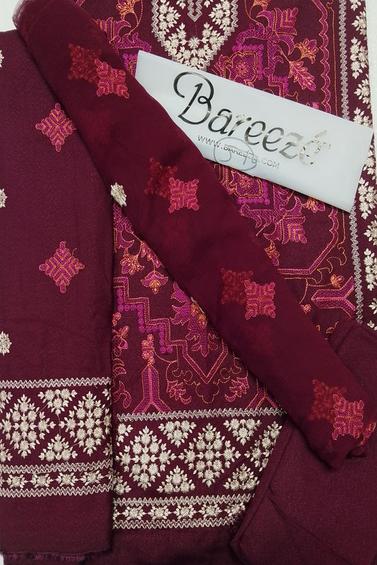 Maroon fabric with intricate patterns and 'Bareeze' branding on a matching fabric background.