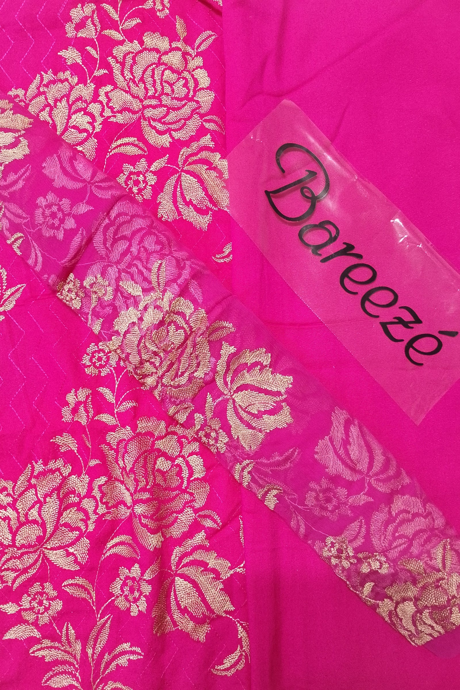 Pink fabric with gold floral patterns and a 'Bareeeze' label.