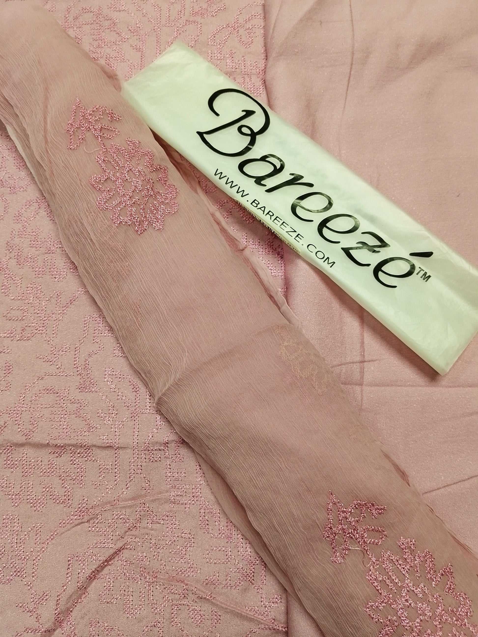 Bareeze product on a pink fabric background