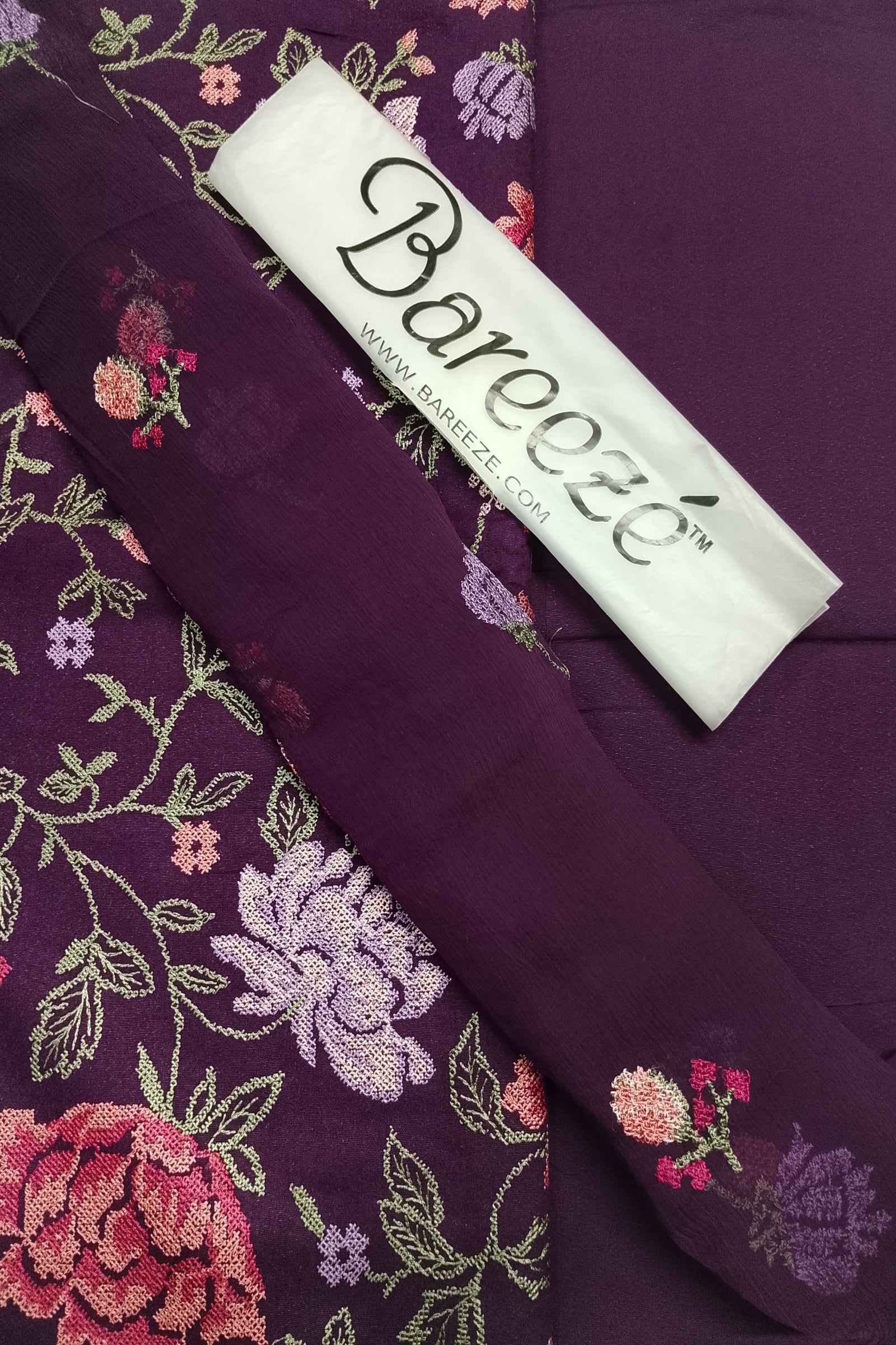 Embroidered fabric with floral patterns and a Bareoeze label.