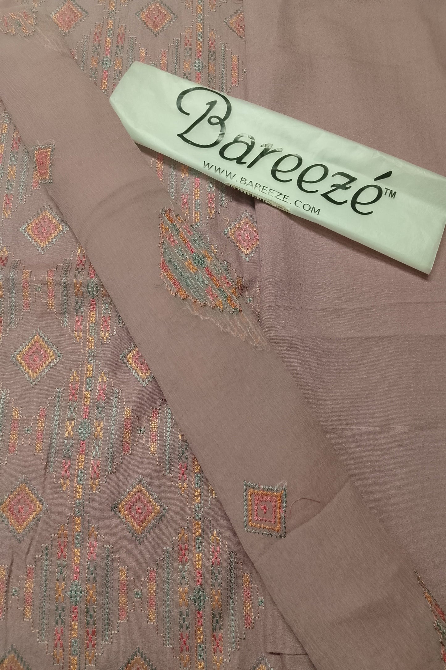Brown fabric with Bareeze label on a matching brown background
