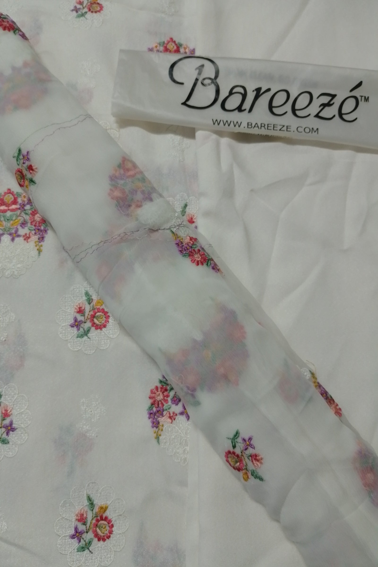 Floral embroidered fabric with Bareezé label