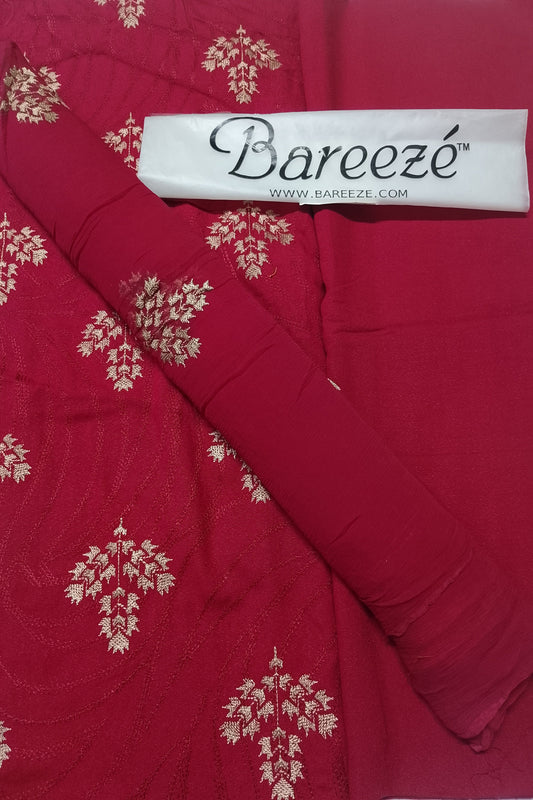 Red fabric with gold floral patterns and Bareezé label on a red background