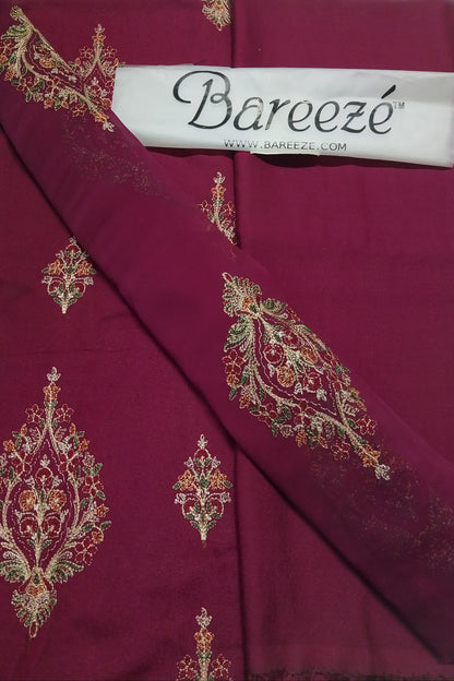 Maroon fabric with intricate gold embroidery and Bareezé label.