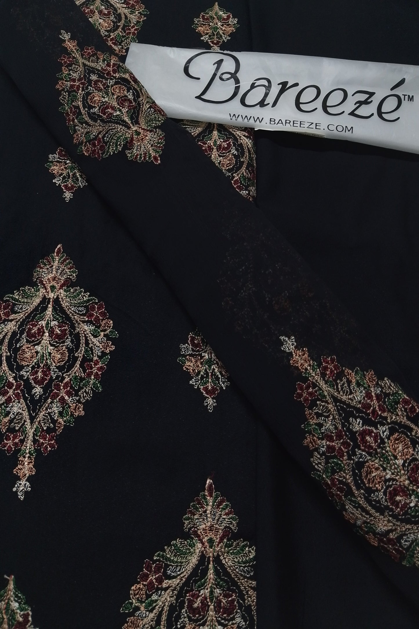 Black fabric with intricate embroidery and Bareezé label