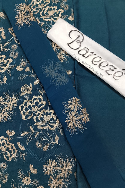 Teal fabric with floral embroidery and Bareeeze label