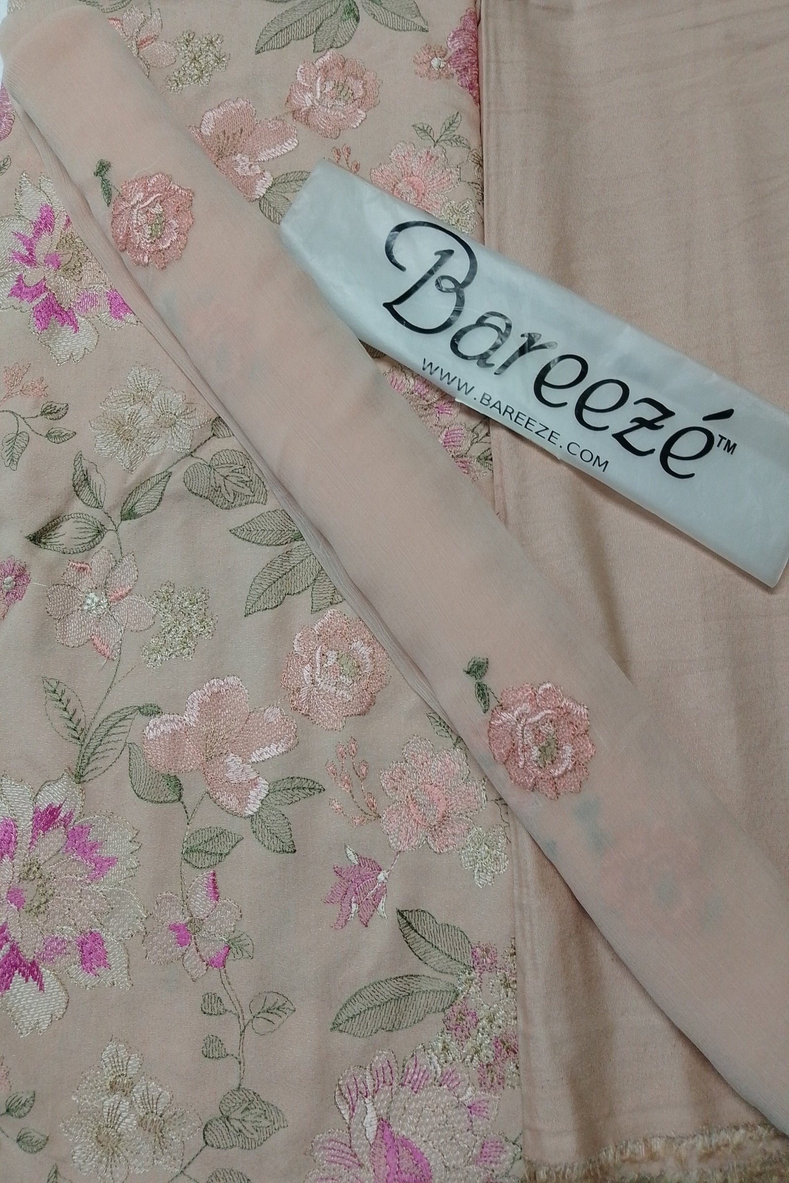 Floral embroidered fabric with a Bareezé label on a floral background