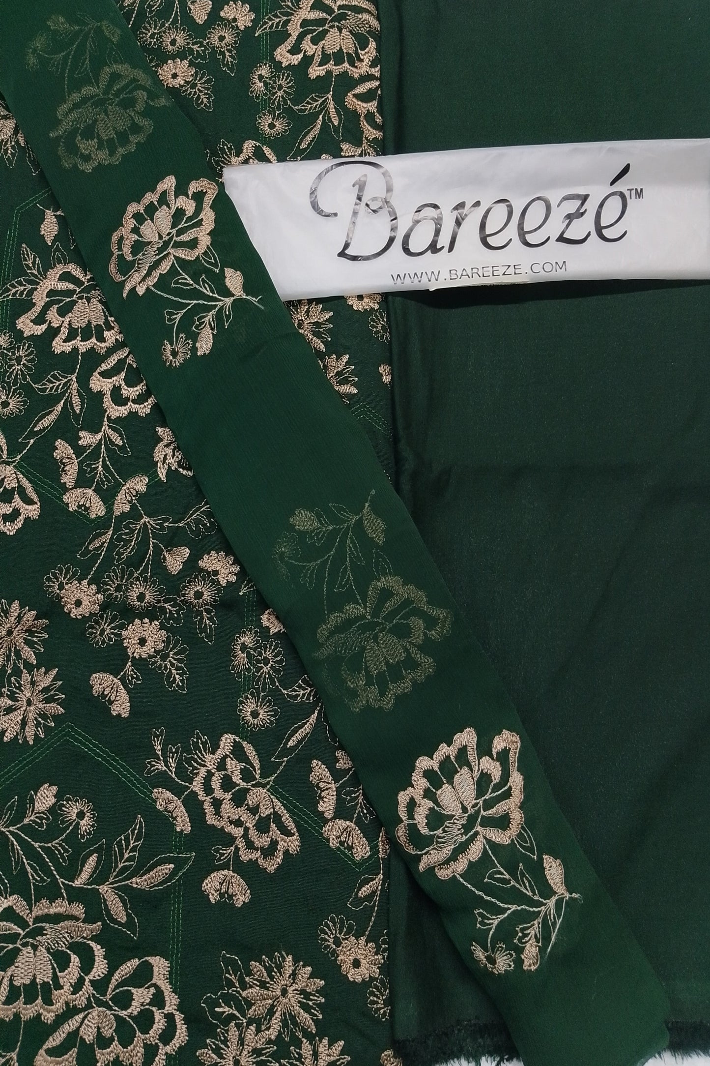Green fabric with floral embroidery and Bareeze label
