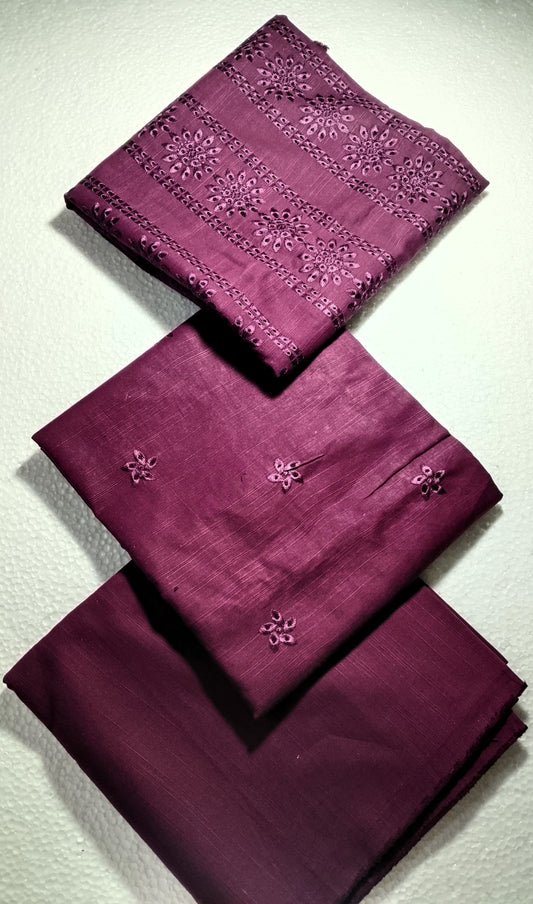Set of purple fabric napkins with floral embroidery on a light gray background
