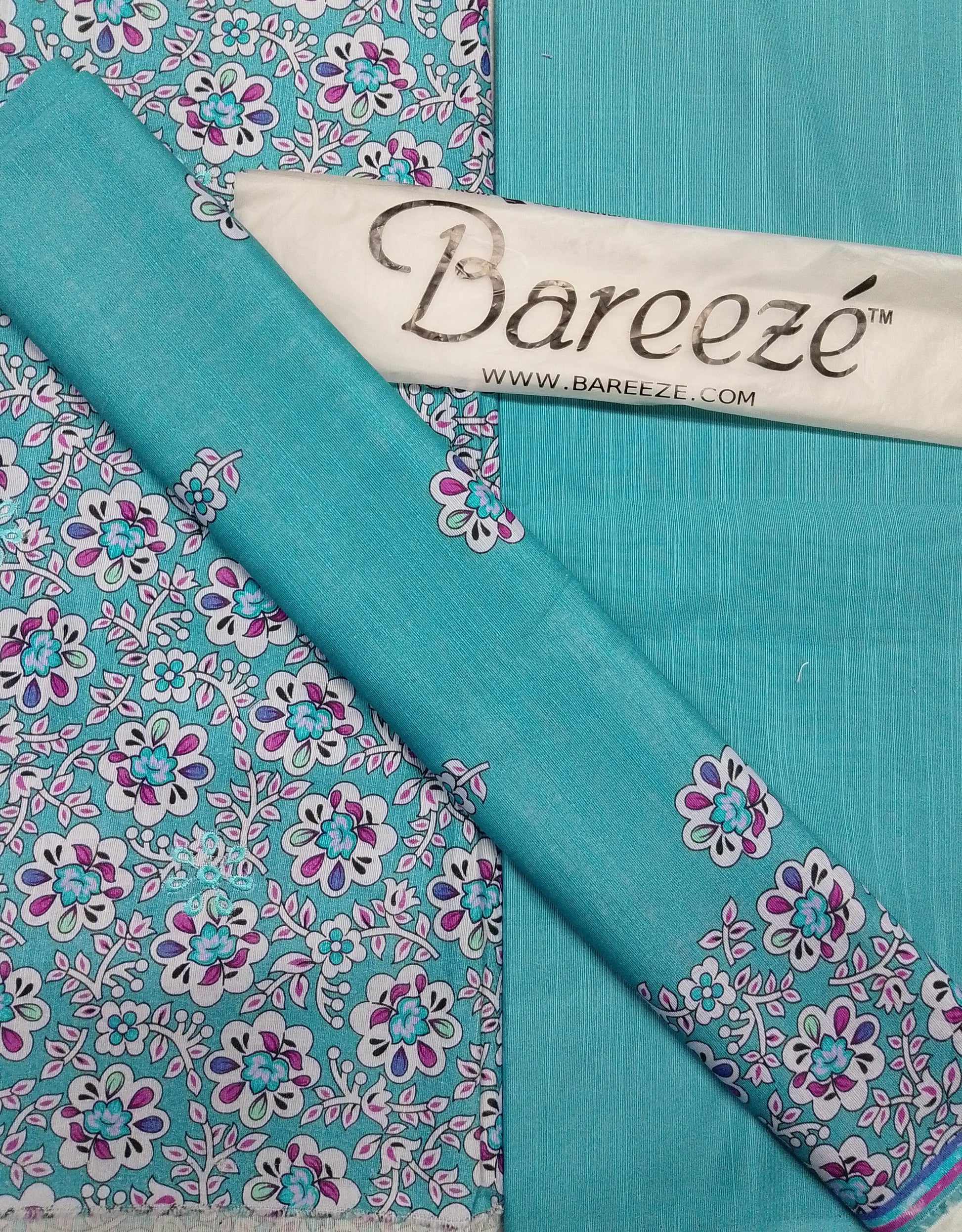 Turquoise fabric with floral patterns and Bareeze branding