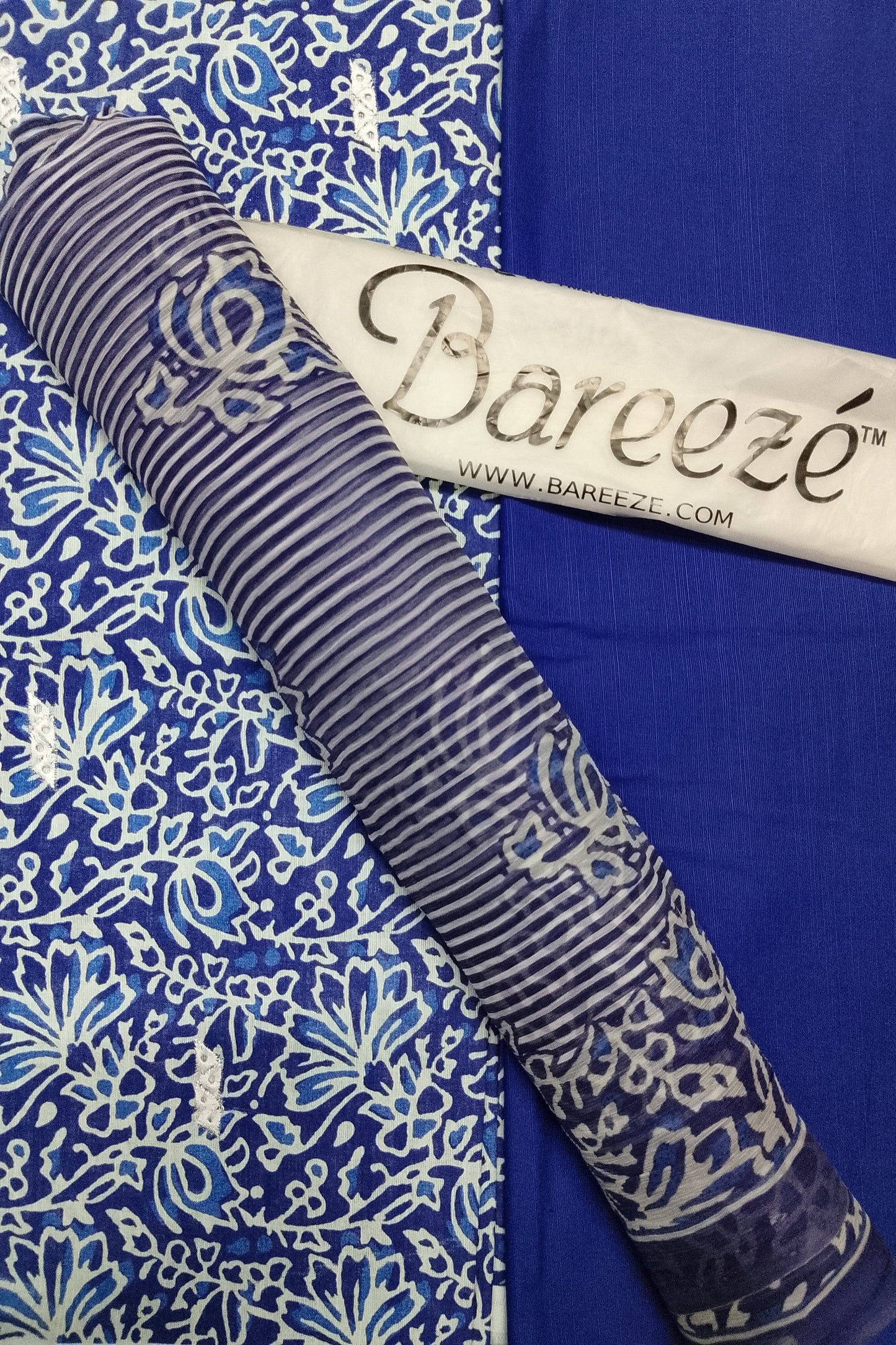 Roll of fabric with a pattern on a blue background, featuring the Bareeze brand.