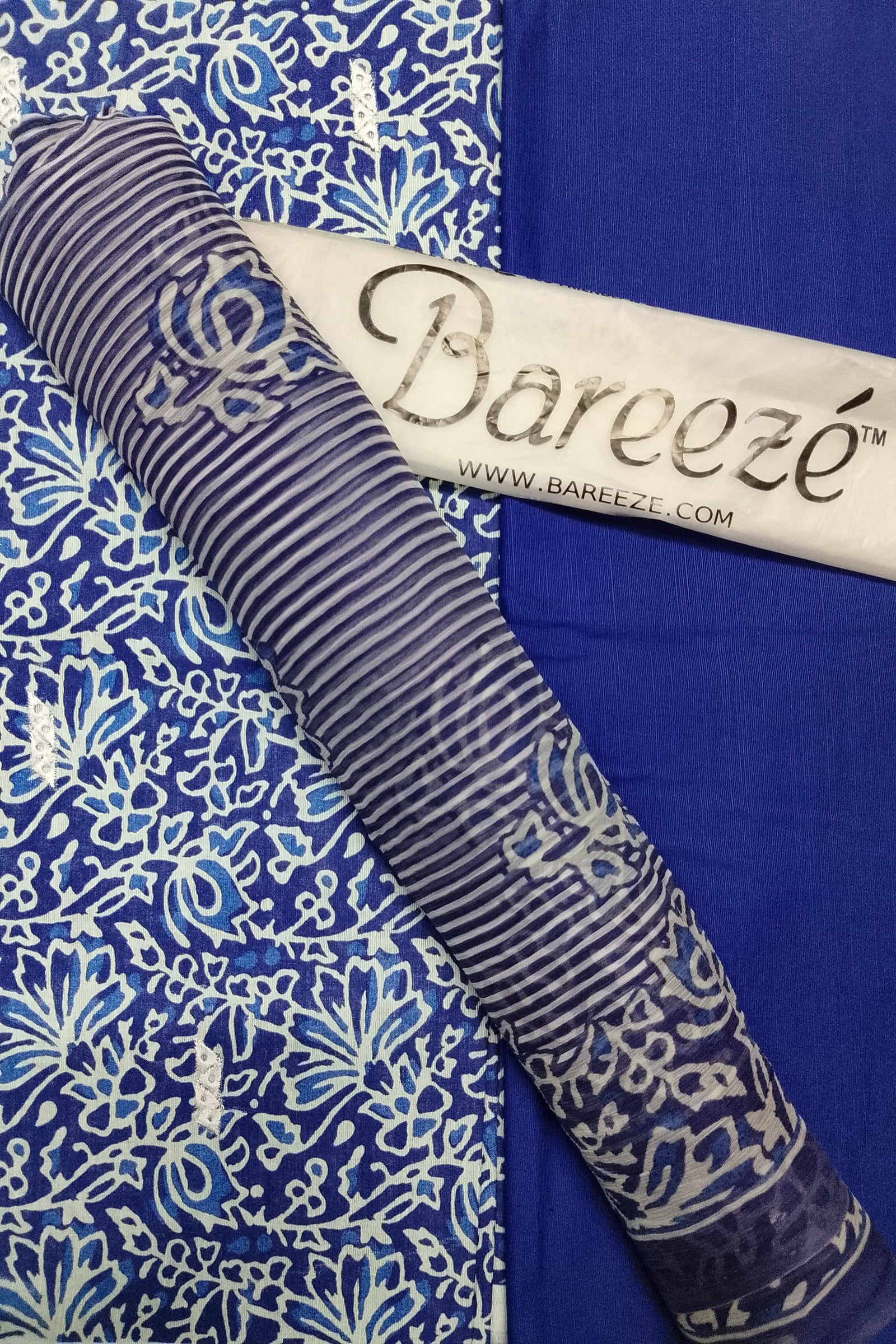 Roll of fabric with a pattern on a blue background, featuring the Bareeze brand.