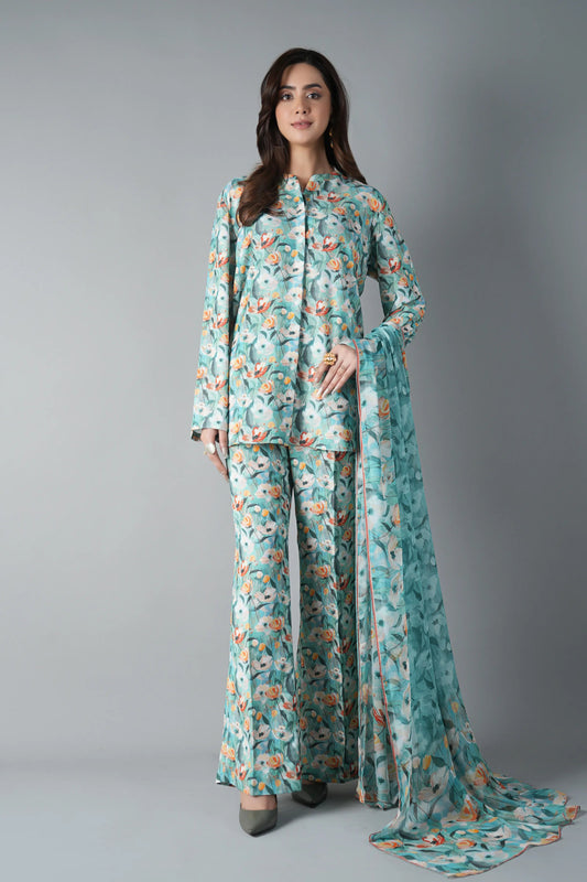 Woman wearing a floral outfit with a long scarf on a gray background