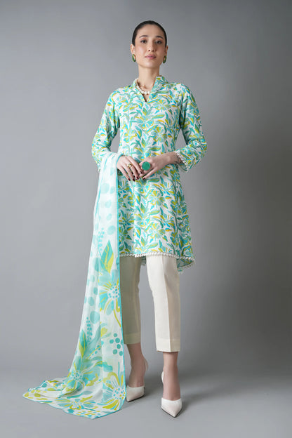 Woman wearing a light green and white patterned outfit with a long scarf on a gray background