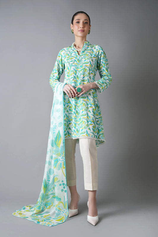 Woman wearing a light green and white patterned outfit with a long scarf on a gray background