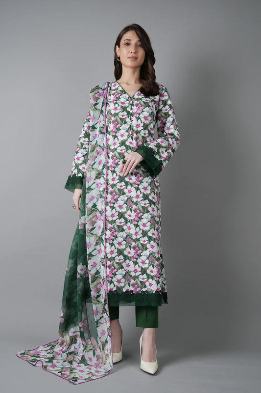 Woman wearing a floral dress with a green dupatta on a gray background