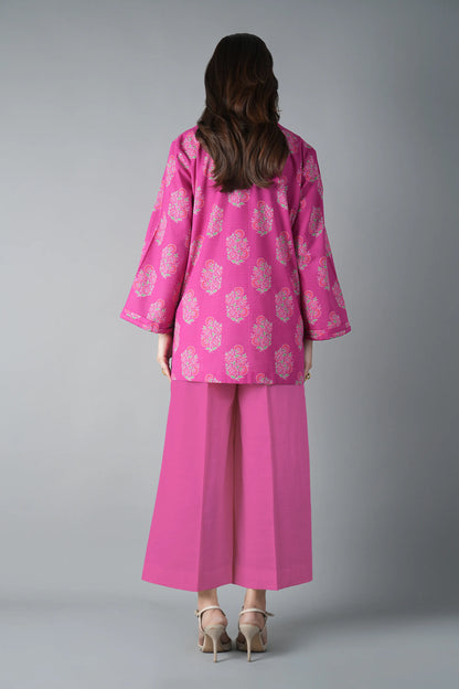 Person wearing a pink outfit with floral patterns on a gray background