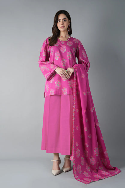 Woman wearing a pink traditional outfit with a matching dupatta on a gray background