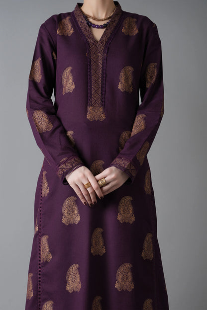 Purple dress with gold patterns on a gray background
