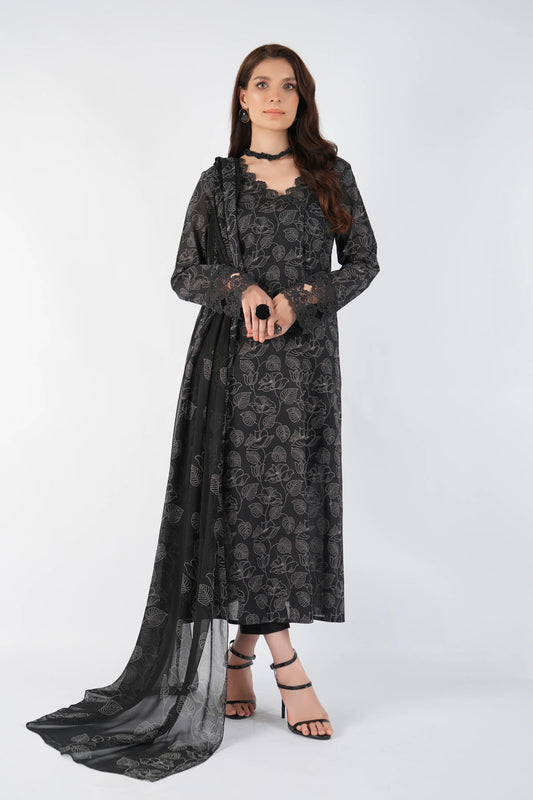 Woman wearing a black floral dress with a sheer overlay on a white background