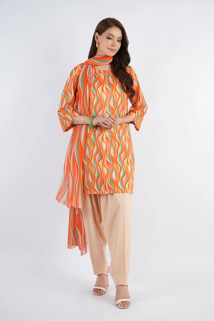 Woman wearing an orange and green patterned kurta with beige pants on a white background